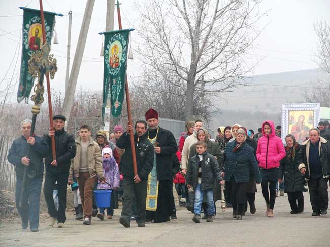 Local Orthodox Church members march through their neighborhood with banners.