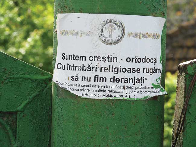 Signs tacked to telephone poles warn: 